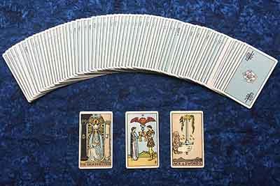 spread of tarot cards on blue cloth