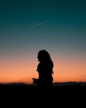 woman looking up at night sky