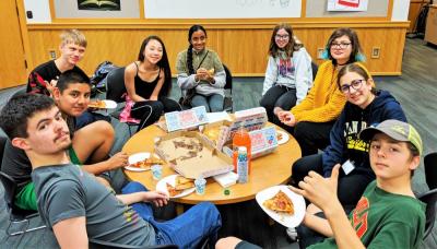 meeting of teens at a TAB meeting eating pizza